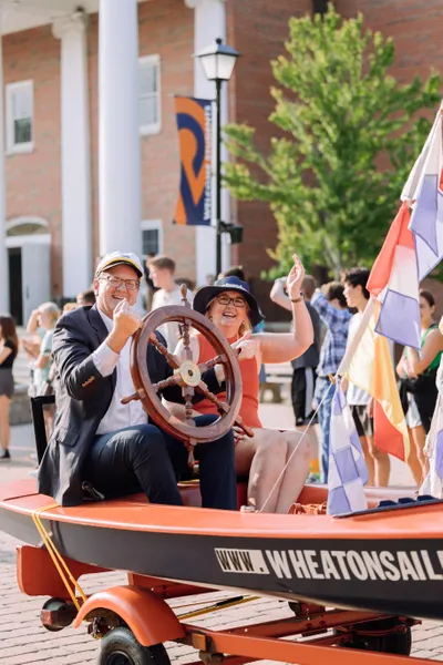 President and Mrs Ryken Riding a Float at 2023 Mastodon March